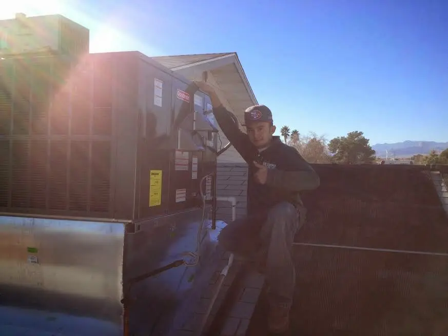 HVAC technician performing Boiler Repair on a rooftop unit in Salem